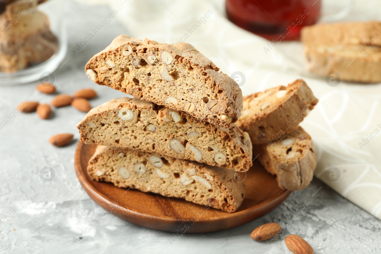 Photo of Traditional Italian almond biscuits (Cantucci) on grey textured table, closeup