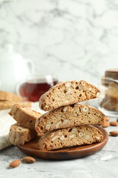 Photo of Traditional Italian almond biscuits (Cantucci) on grey textured table, closeup