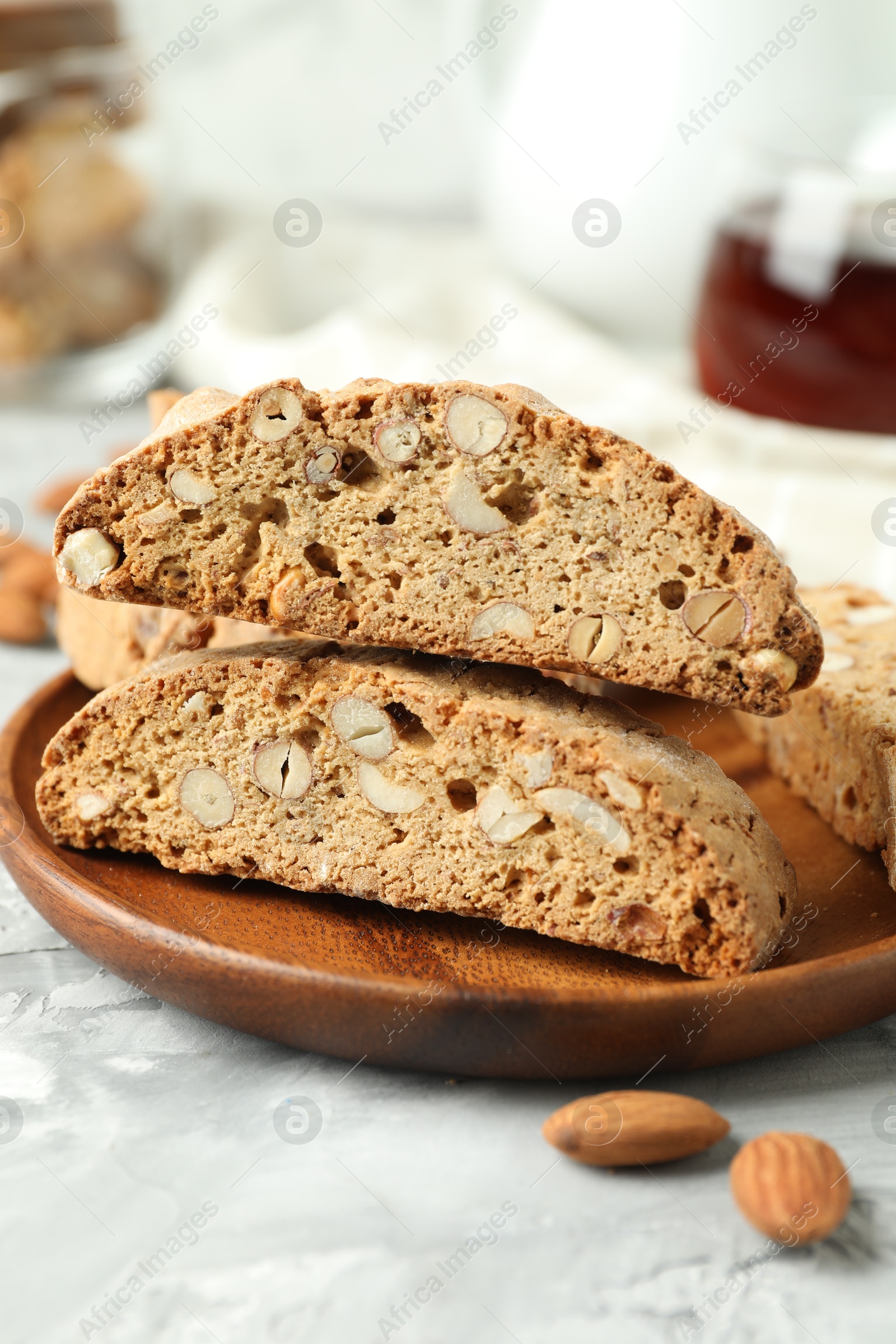 Photo of Traditional Italian almond biscuits (Cantucci) on grey textured table, closeup