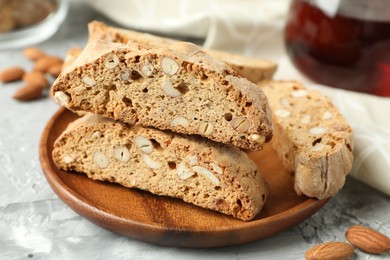 Photo of Traditional Italian almond biscuits (Cantucci) on grey textured table, closeup