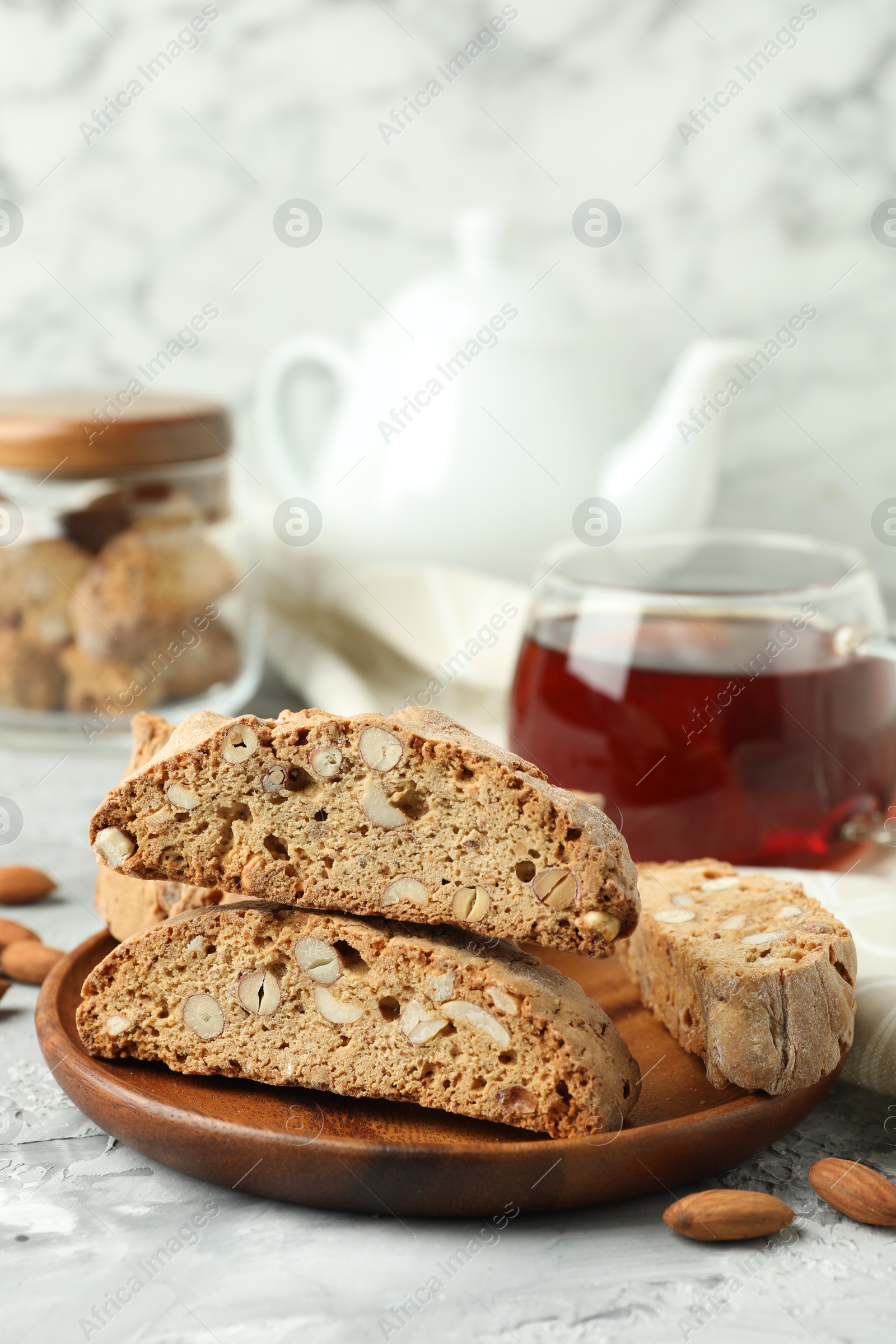 Photo of Traditional Italian almond biscuits (Cantucci) on grey textured table, closeup