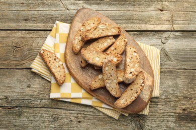 Photo of Traditional Italian almond biscuits (Cantucci) on wooden table, flat lay