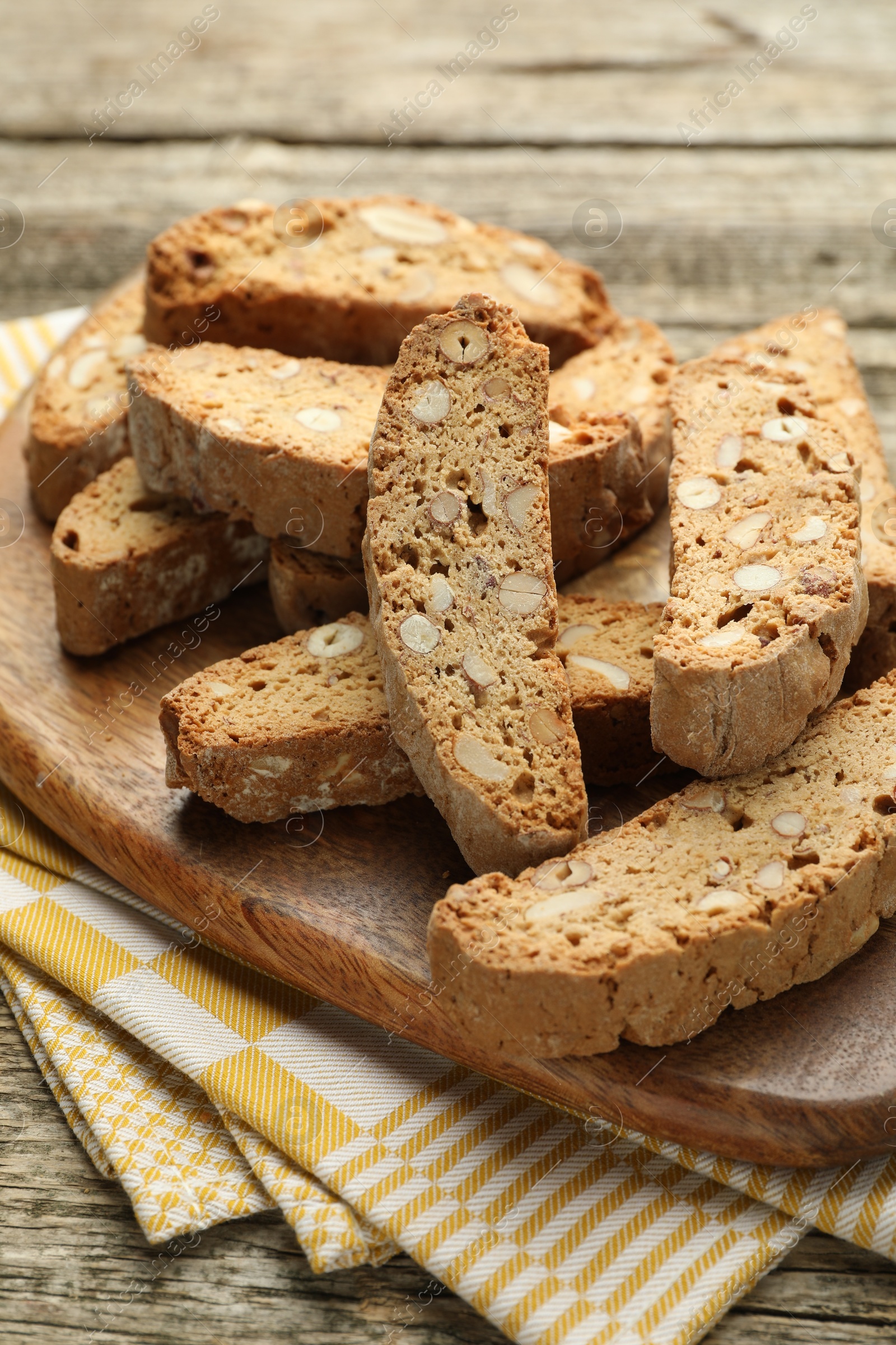 Photo of Traditional Italian almond biscuits (Cantucci) on wooden table, closeup