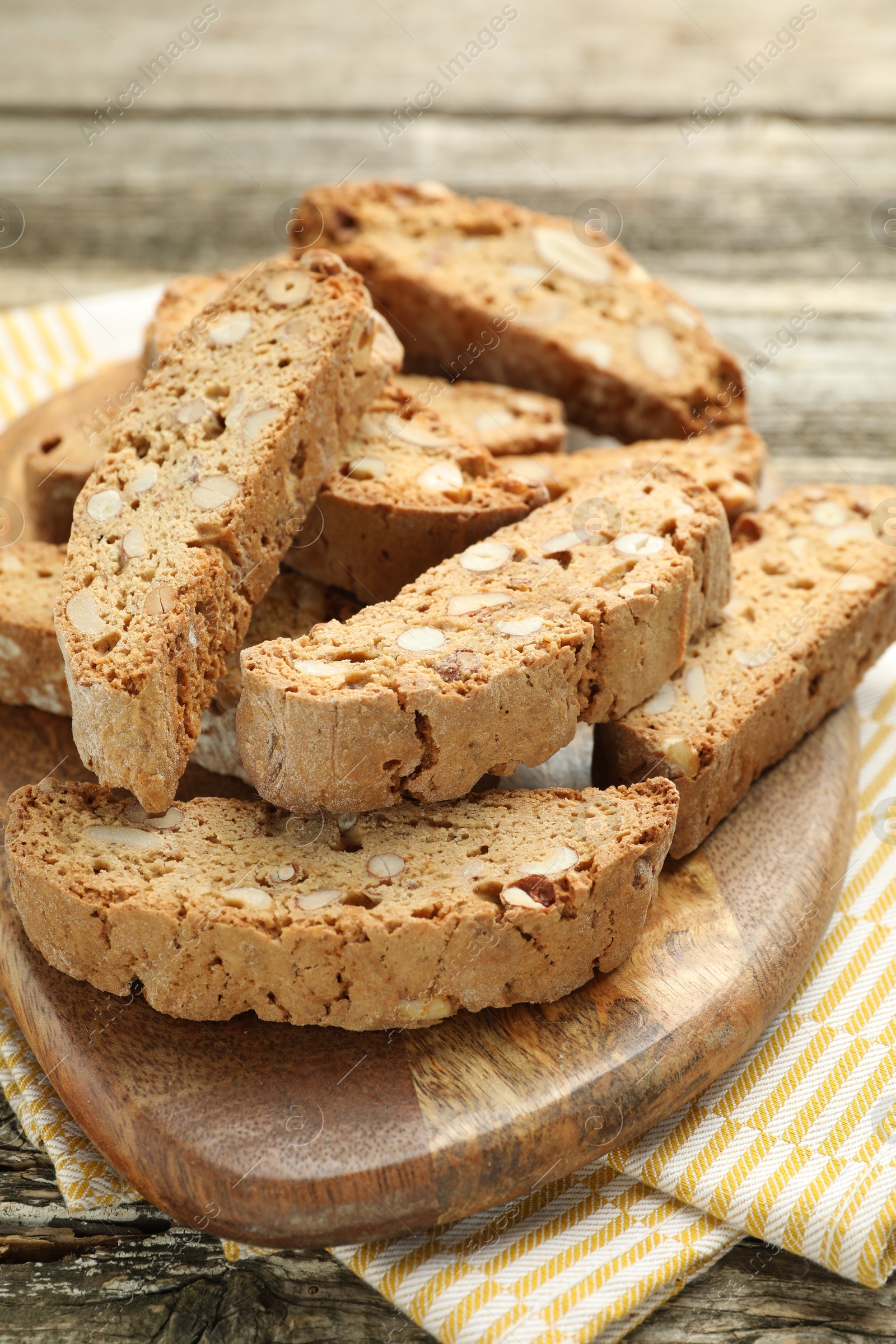 Photo of Traditional Italian almond biscuits (Cantucci) on wooden table, closeup