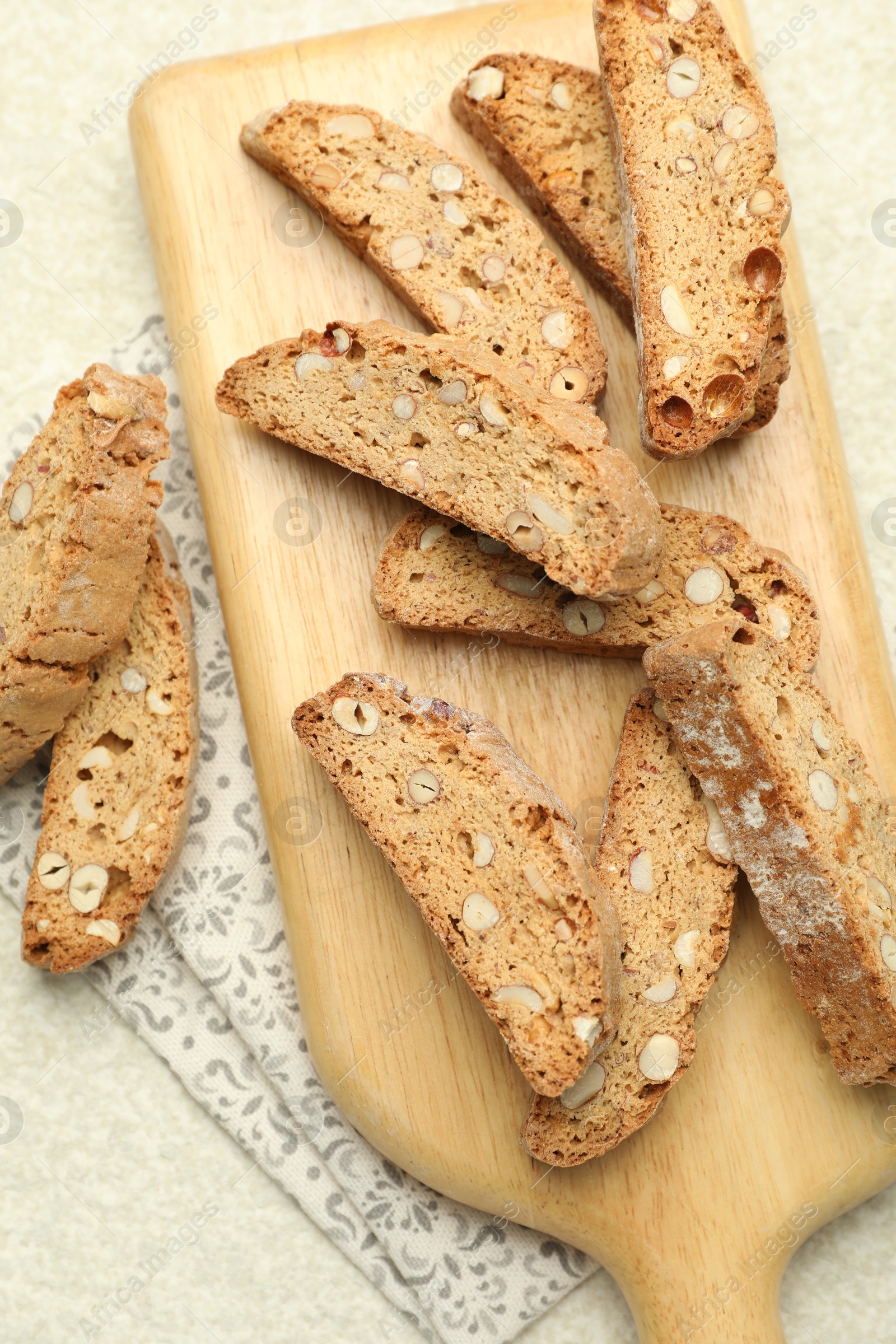 Photo of Traditional Italian almond biscuits (Cantucci) on light textured table, flat lay