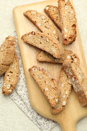 Traditional Italian almond biscuits (Cantucci) on light textured table, flat lay