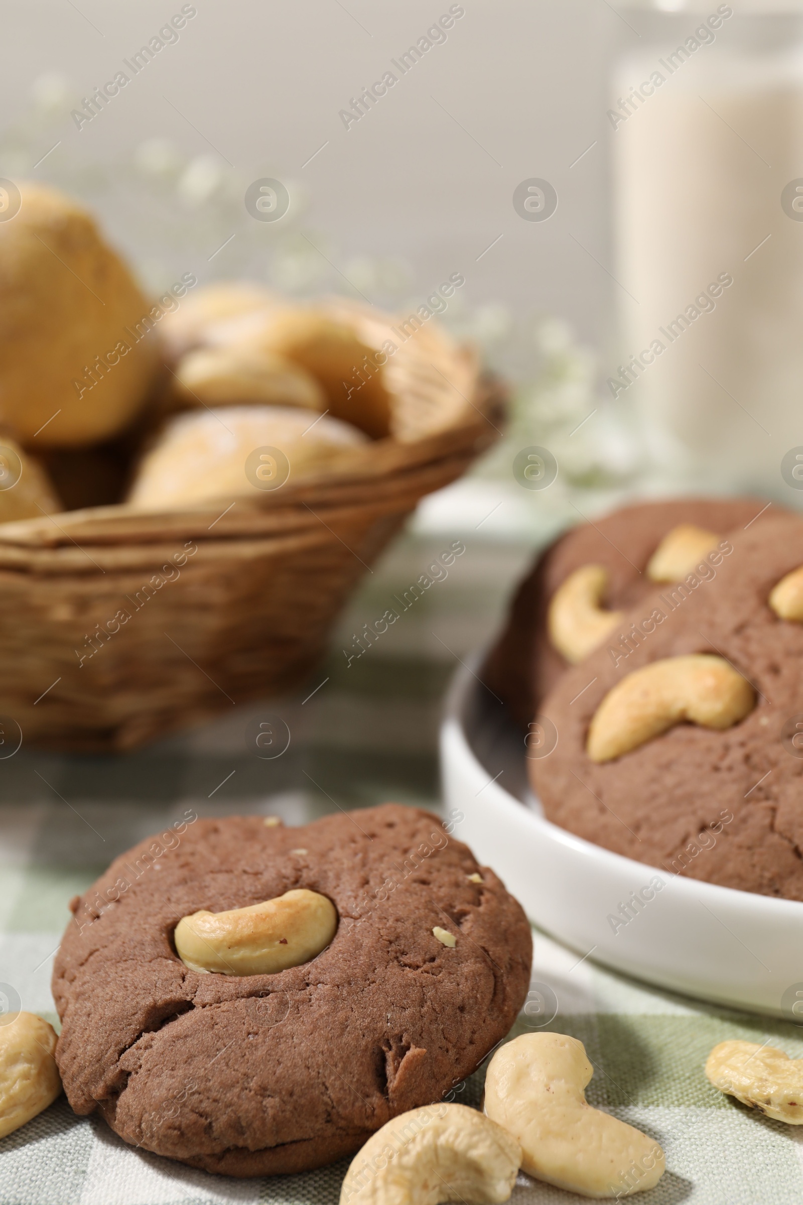 Photo of Tasty chocolate cookies with cashew on table, closeup