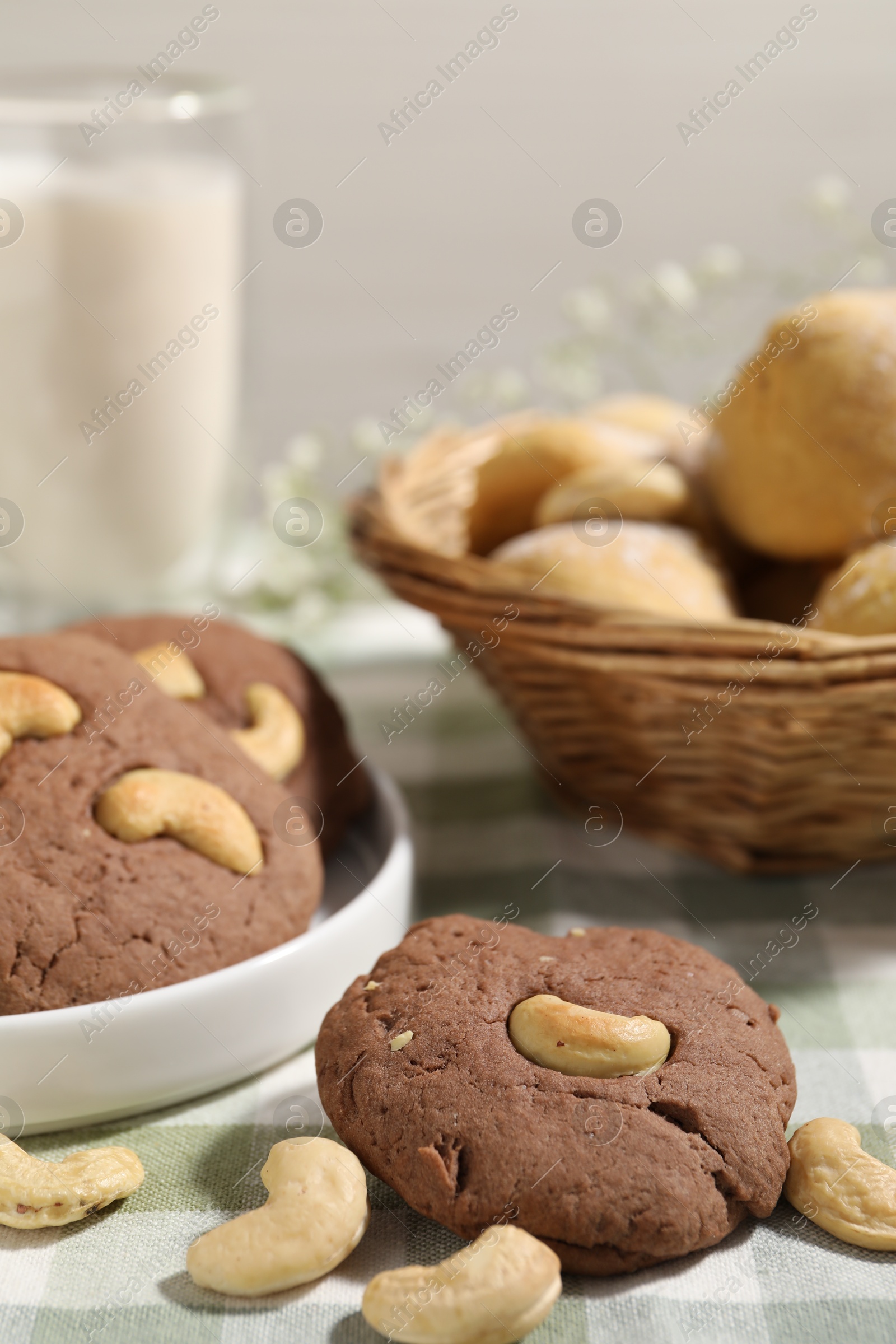 Photo of Tasty chocolate cookies with cashew on table, closeup