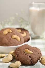 Photo of Tasty chocolate cookies with cashew on table, closeup