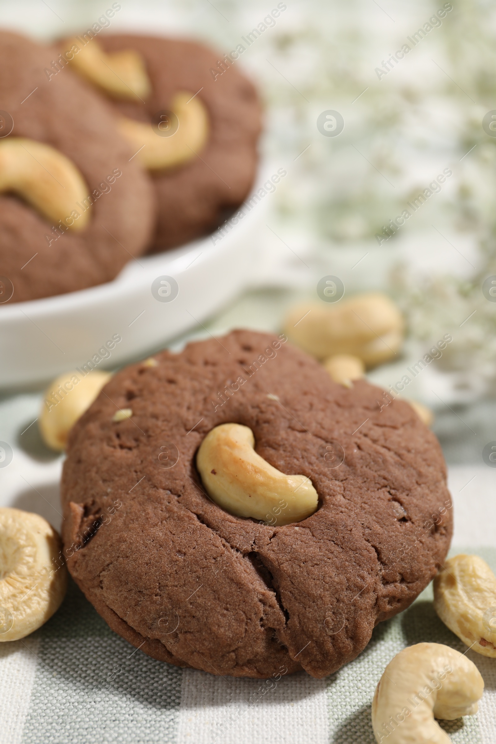 Photo of Tasty chocolate cookies with cashew on table, closeup