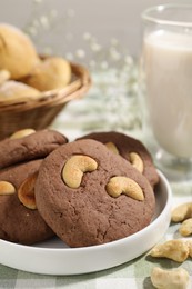 Photo of Tasty chocolate cookies with cashew on table, closeup