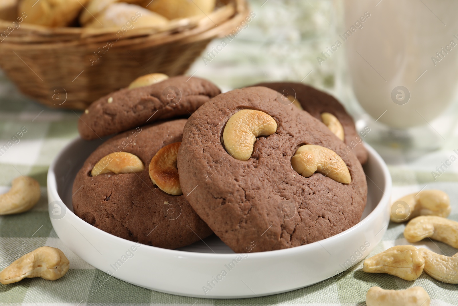 Photo of Tasty chocolate cookies with cashew on table, closeup