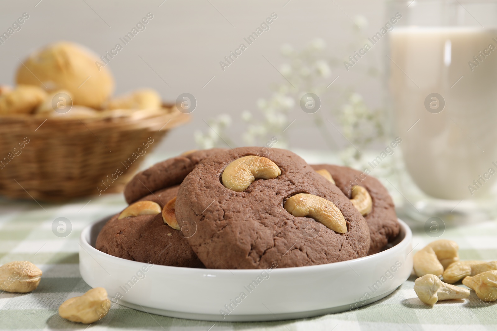 Photo of Tasty chocolate cookies with cashew on table, closeup