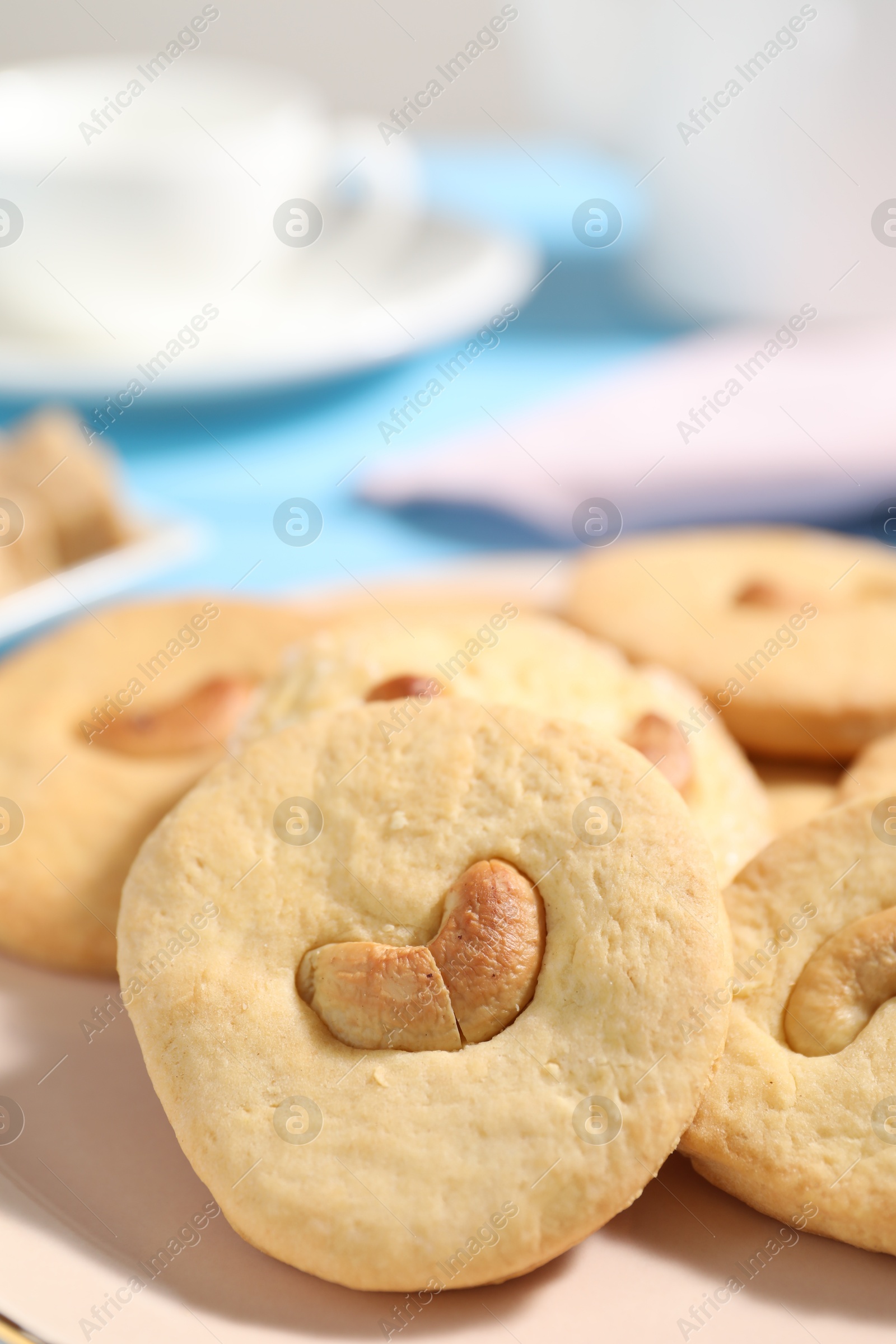 Photo of Plate with tasty cashew cookies on table, closeup