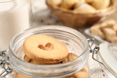 Photo of Tasty cashew cookies in jar on table, closeup