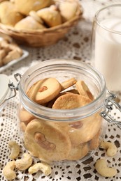 Photo of Tasty cashew cookies in jar on table, closeup