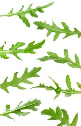 Fresh green arugula in air on white background