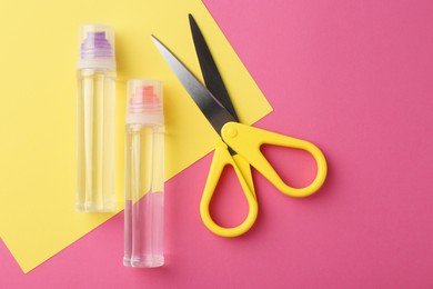 Photo of Glue, colorful paper and scissors on pink background, flat lay