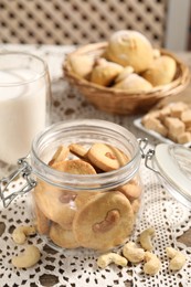 Photo of Tasty cashew cookies in jar on table, closeup