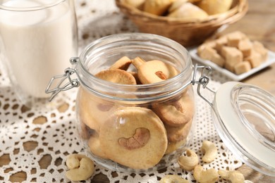 Photo of Tasty cashew cookies in jar on table, closeup