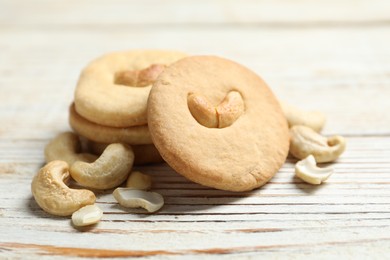 Photo of Tasty cashew cookies on rustic wooden table, closeup