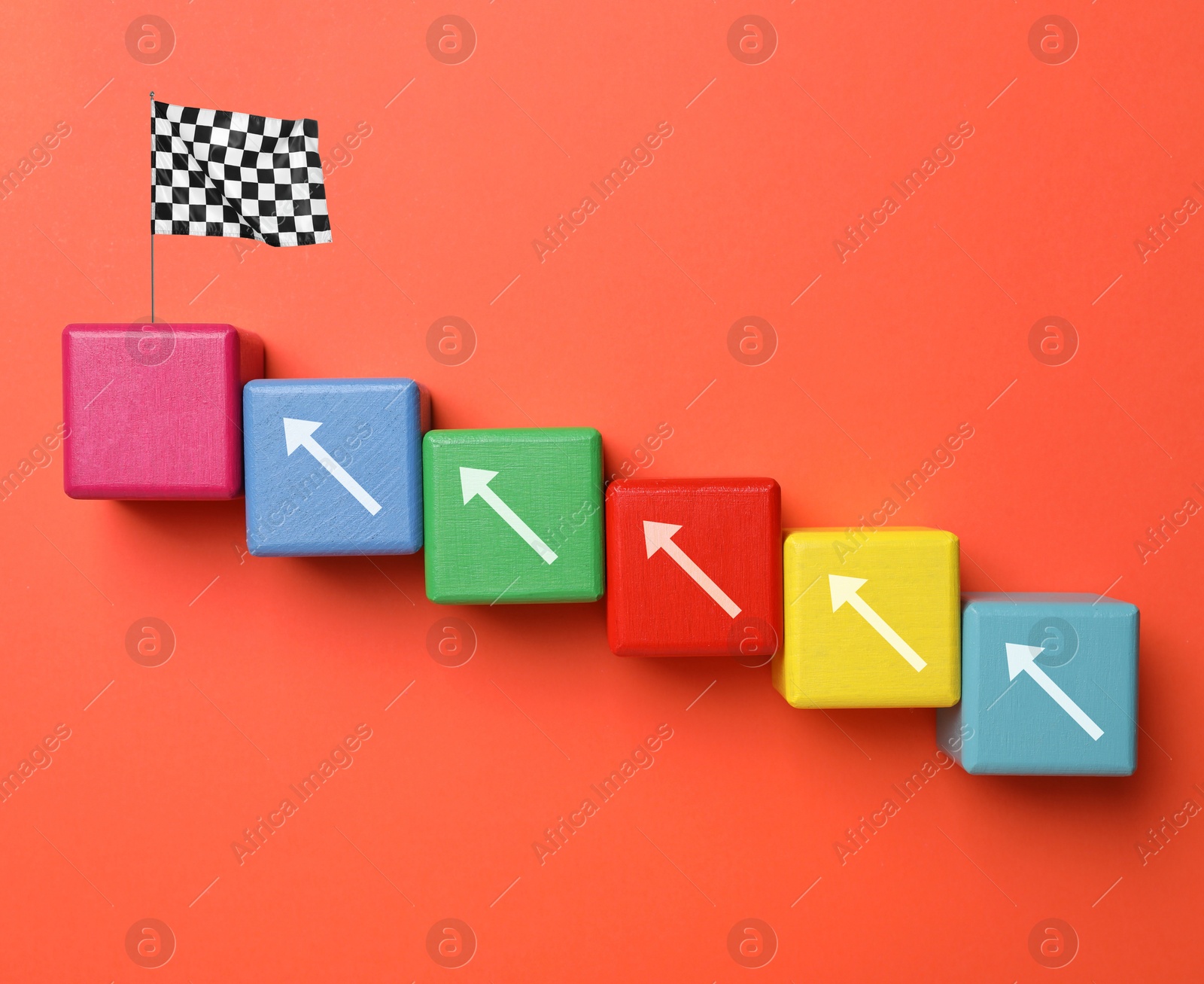 Image of Colorful cubes with arrows and last one with finish flag on dark orange background, top view. Steps to success concept