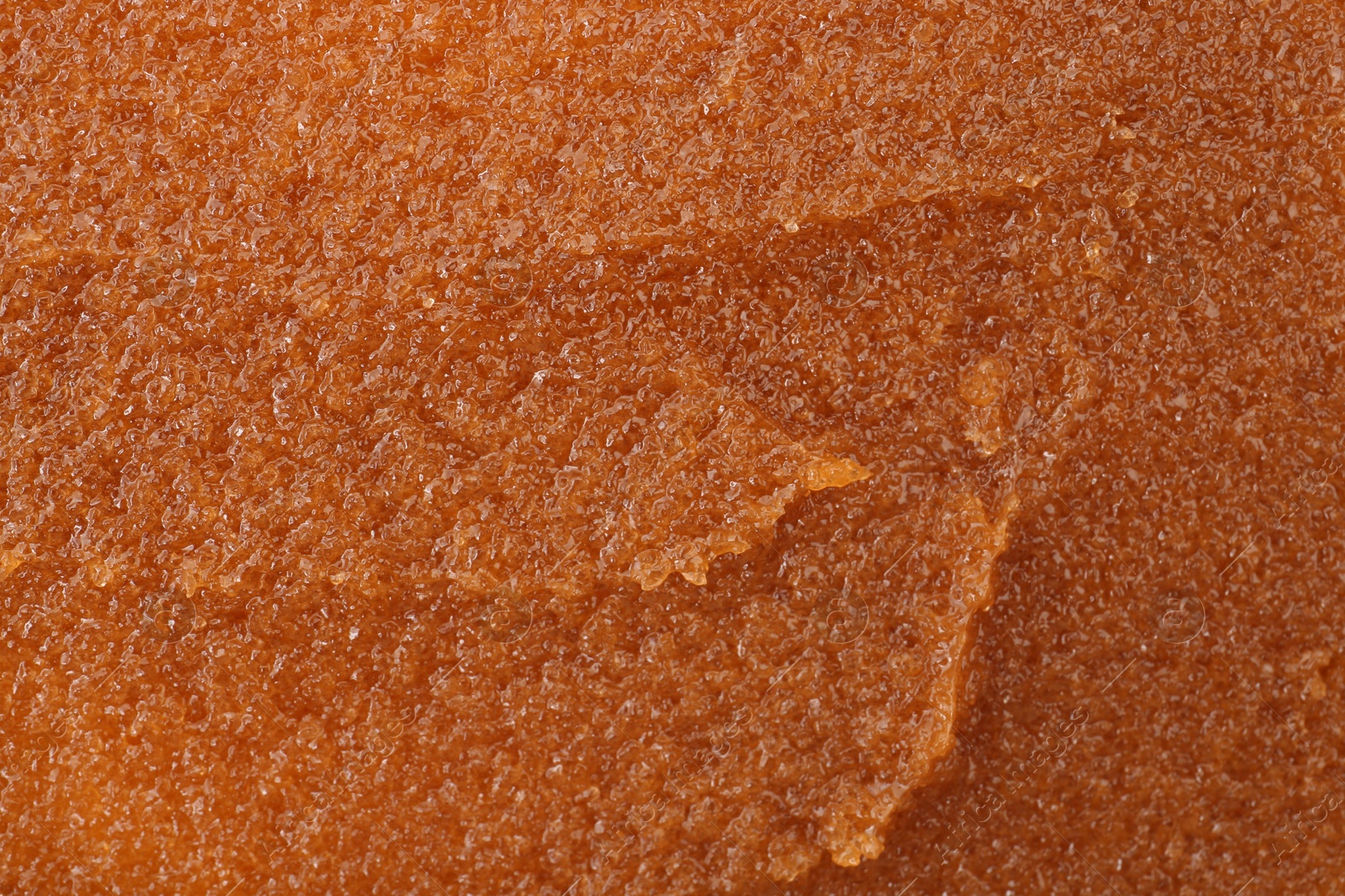 Photo of Sample of natural body scrub as background, closeup