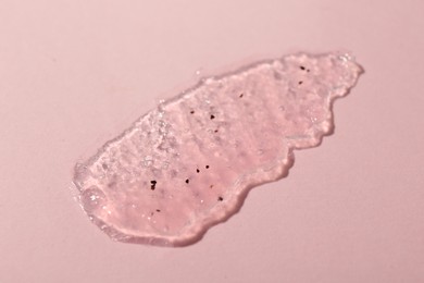 Smear of body scrub on light pink background, top view