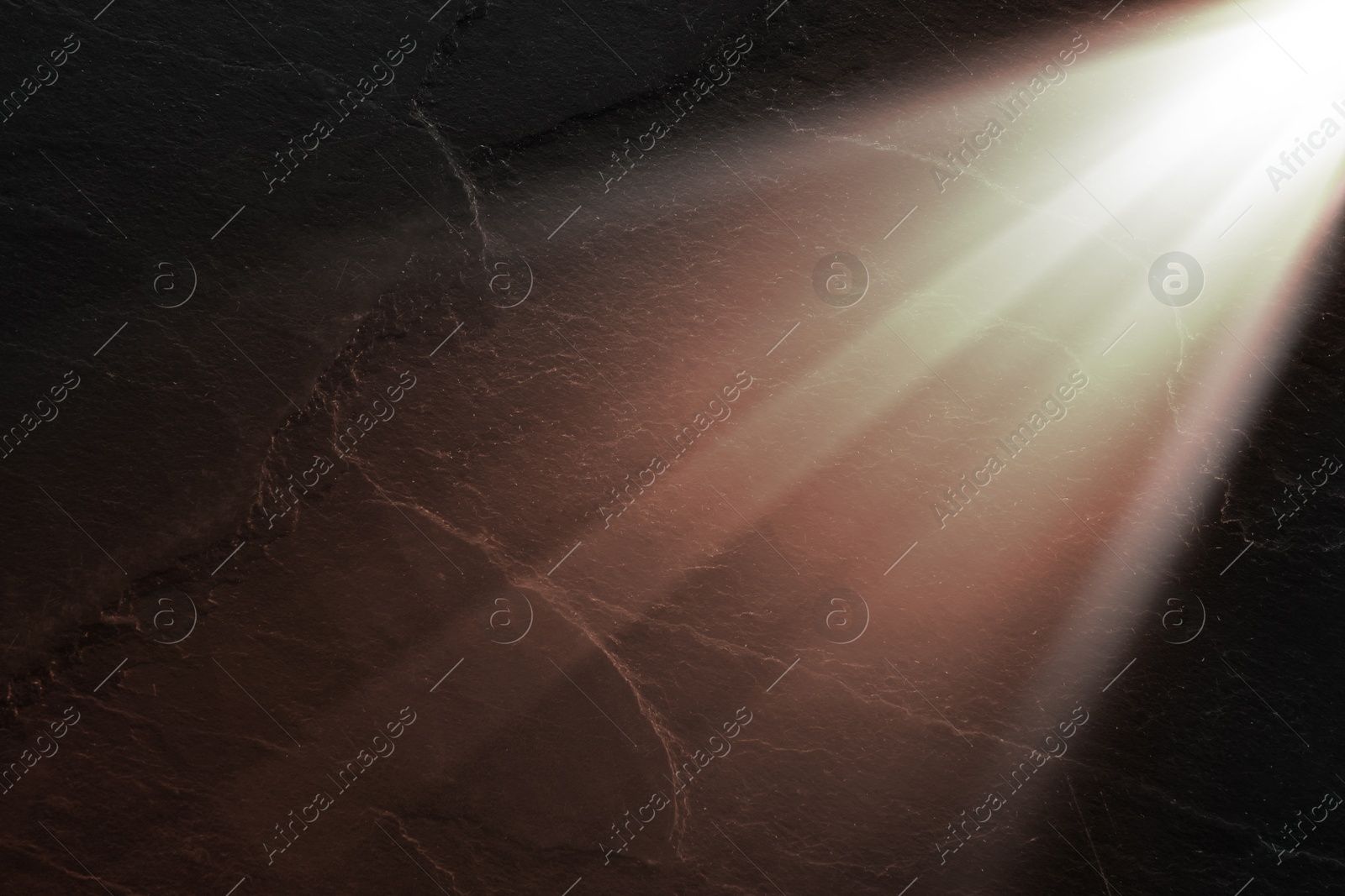 Image of Ray of bright divine light in darkness