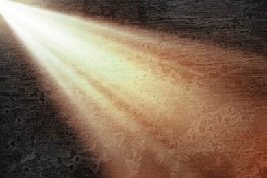 Image of Ray of bright divine light in darkness