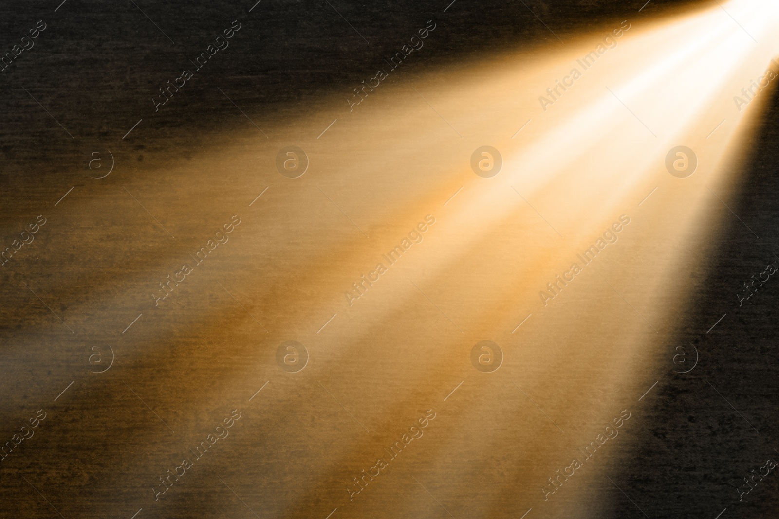 Image of Ray of bright divine light in darkness