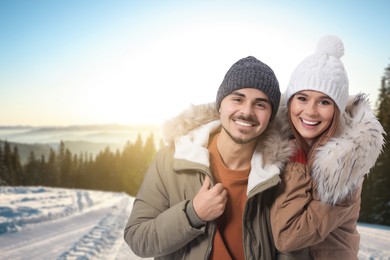 Happy couple in mountains on winter day