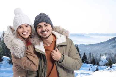 Image of Happy couple in mountains on winter day