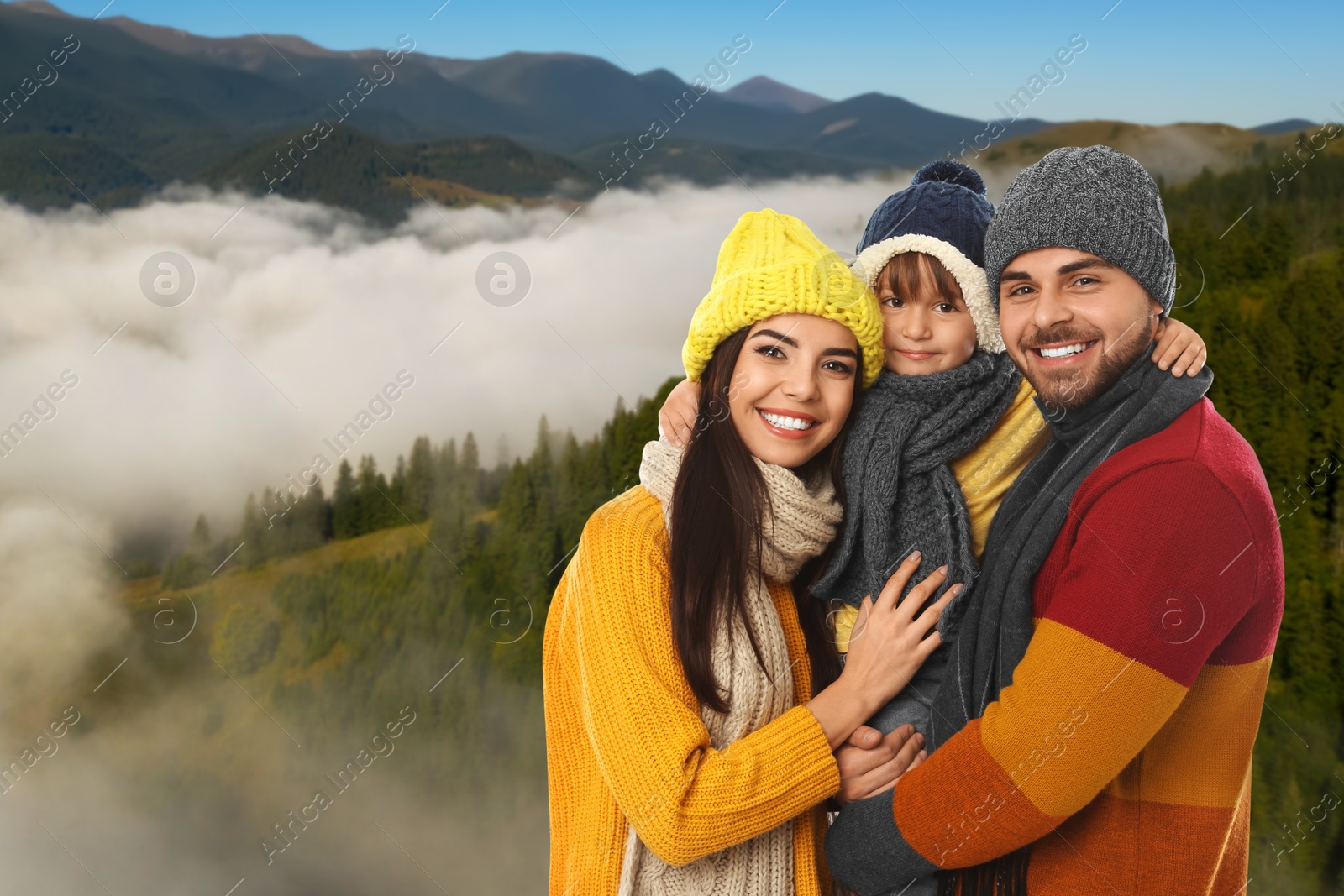 Image of Portrait of happy family with child in mountains