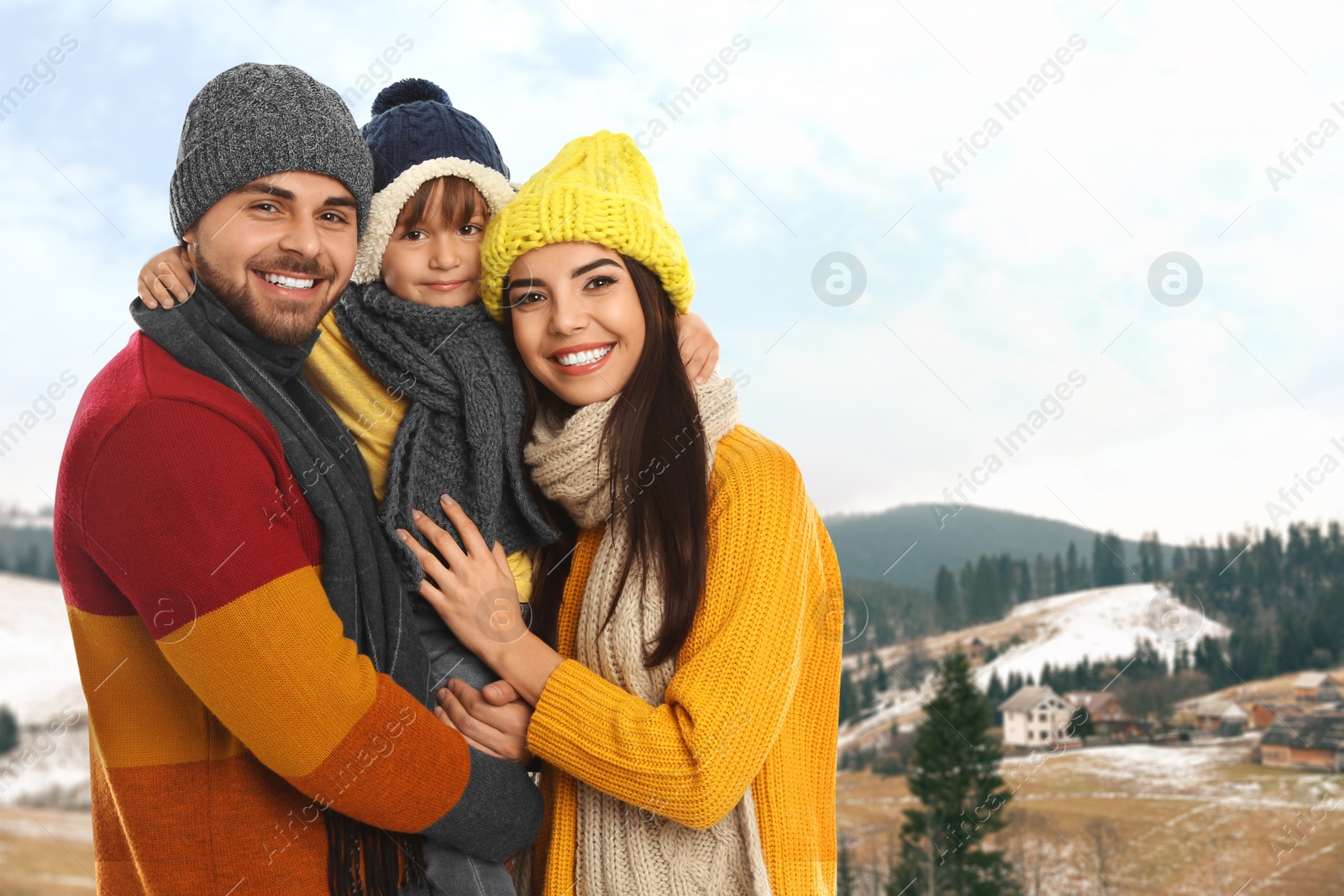 Image of Portrait of happy family with child in mountains