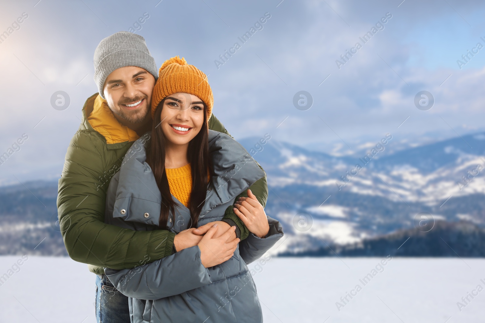 Image of Happy couple in mountains on winter day