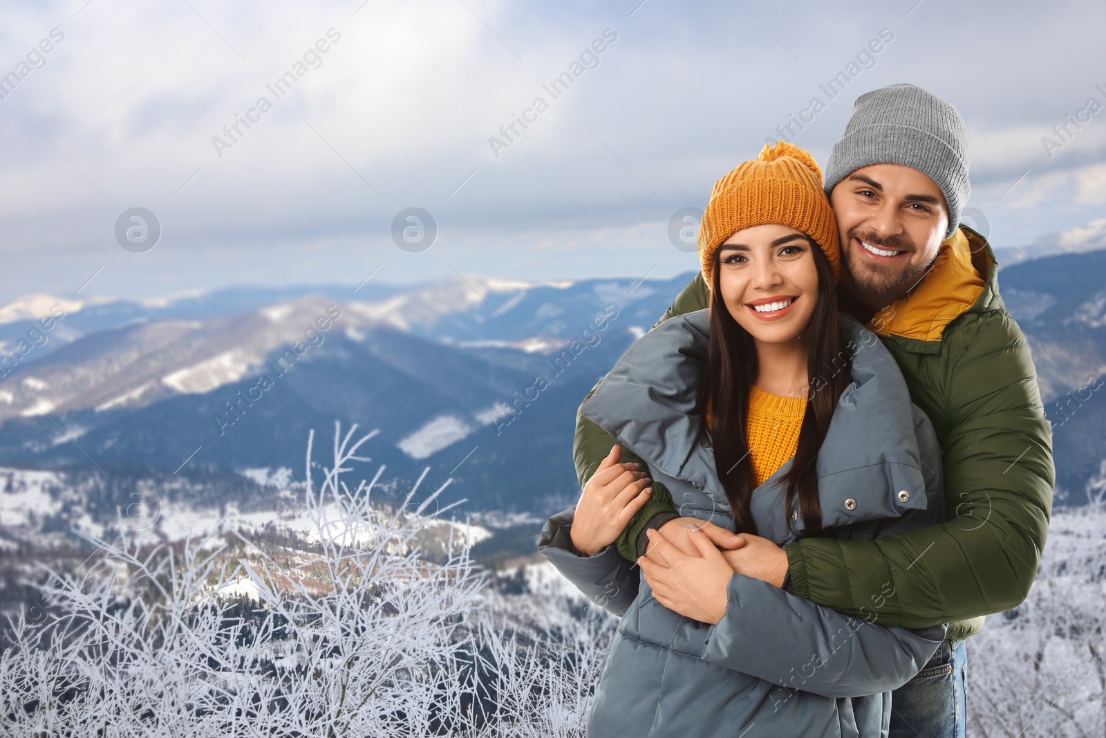 Image of Happy couple in mountains on winter day