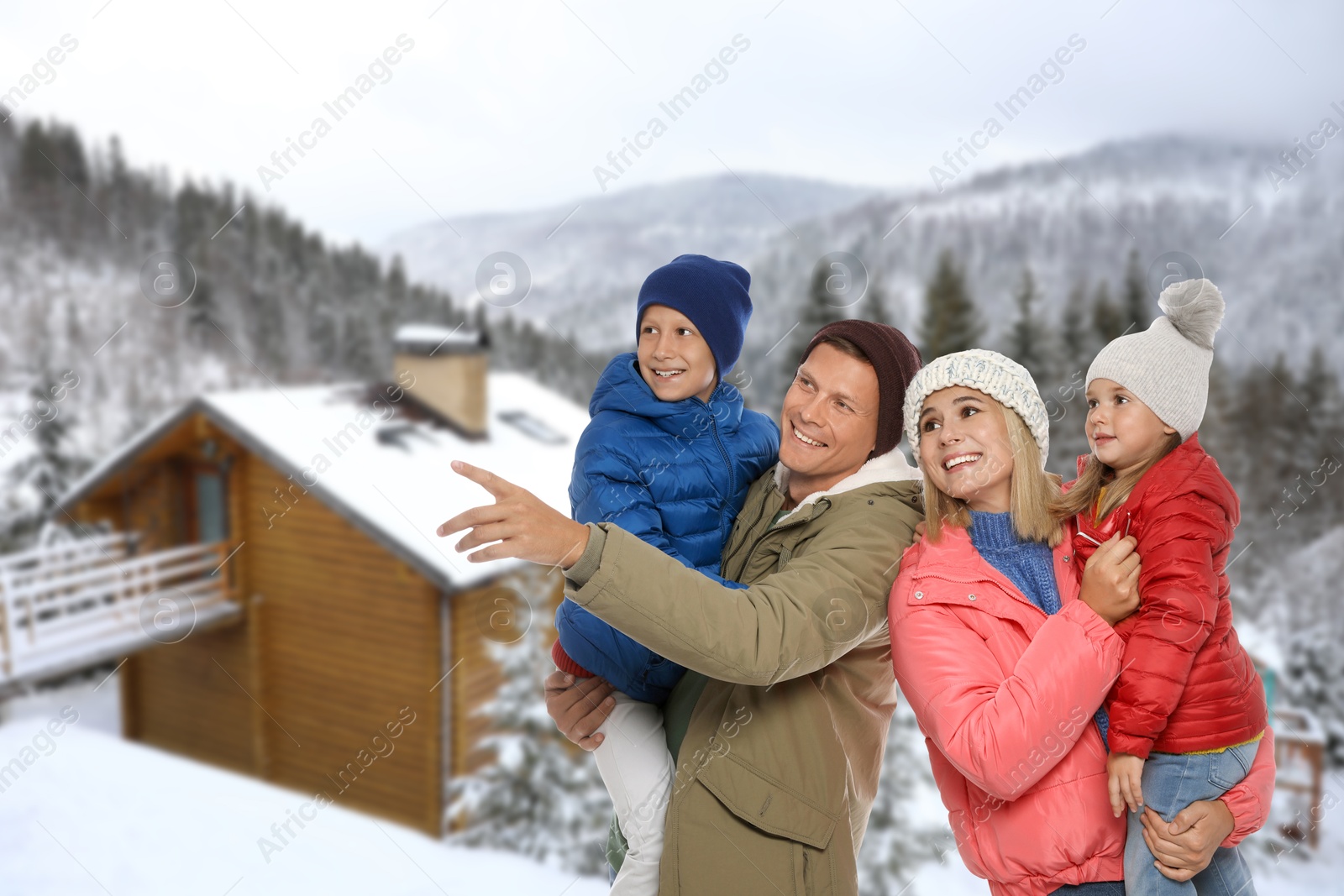 Image of Portrait of happy family with children in mountains on winter day