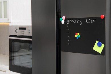 Magnetic board with grocery list and note on refrigerator in kitchen