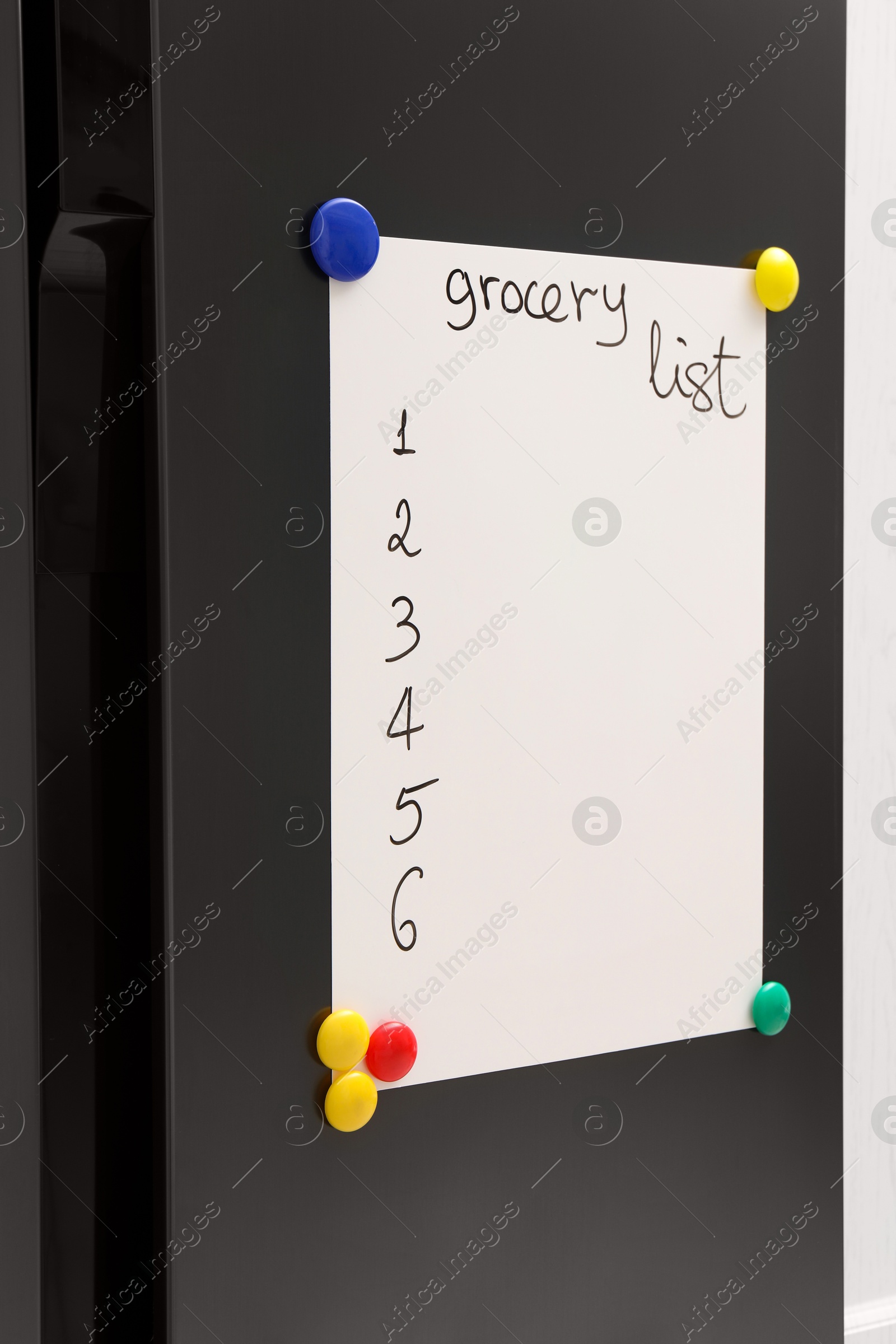 Photo of Magnetic board with grocery list on refrigerator in kitchen