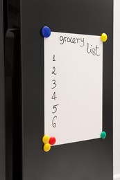 Photo of Magnetic board with grocery list on refrigerator in kitchen