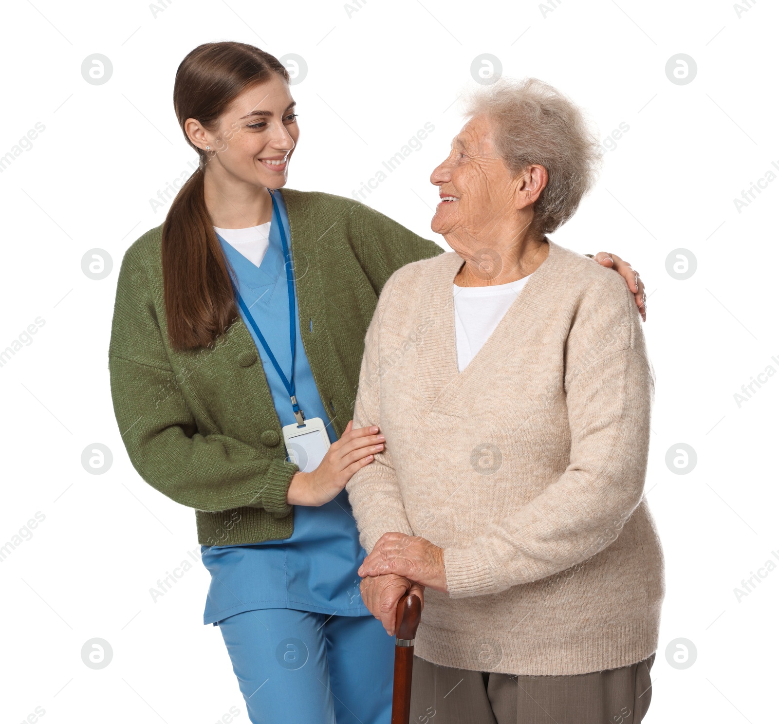 Photo of Caregiver supporting senior woman with walking cane on white background. Home health care service