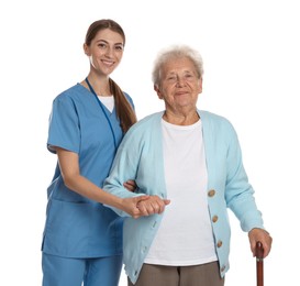 Photo of Caregiver supporting senior woman with walking cane on white background. Home health care service