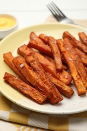 Delicious sweet potato fries on table, closeup