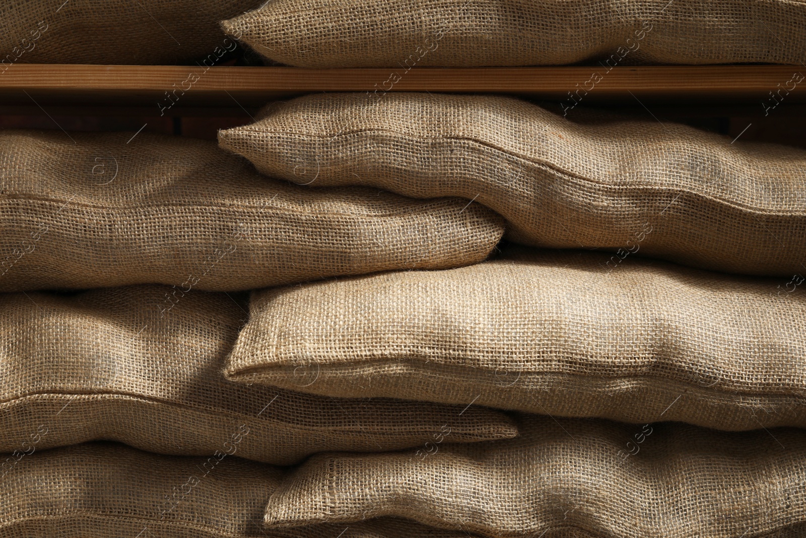 Photo of Group of burlap sacks on shelving unit, closeup