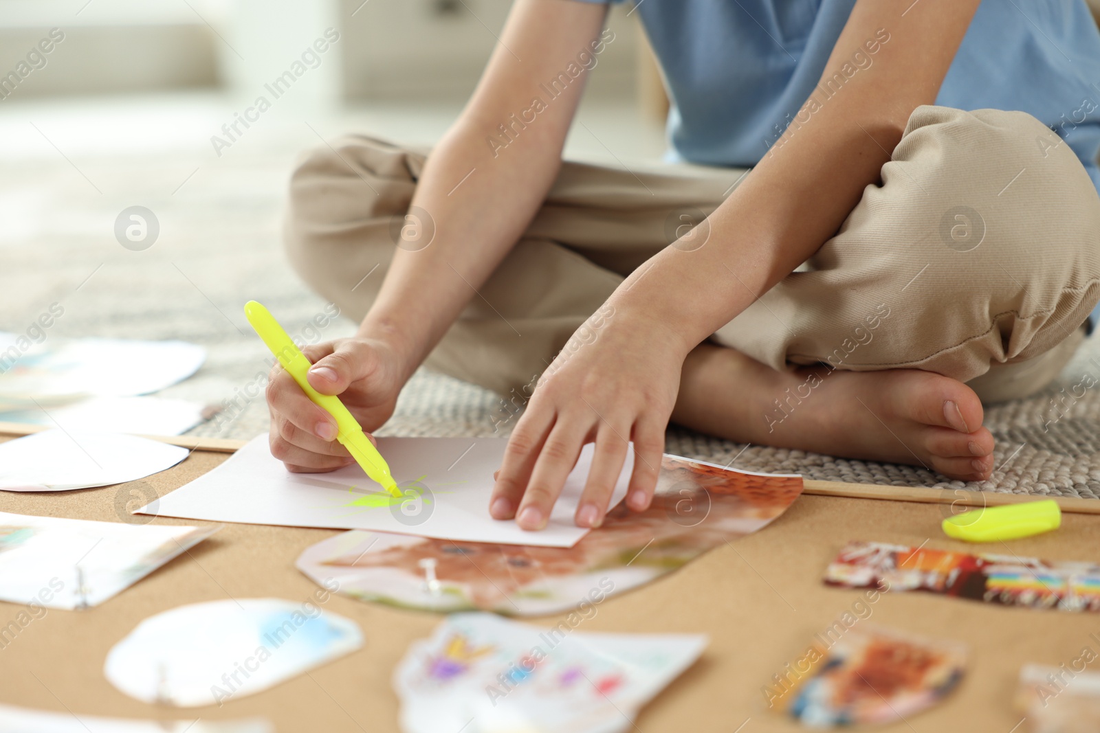 Photo of Creating vision board. Little boy drawing on paper indoors, closeup