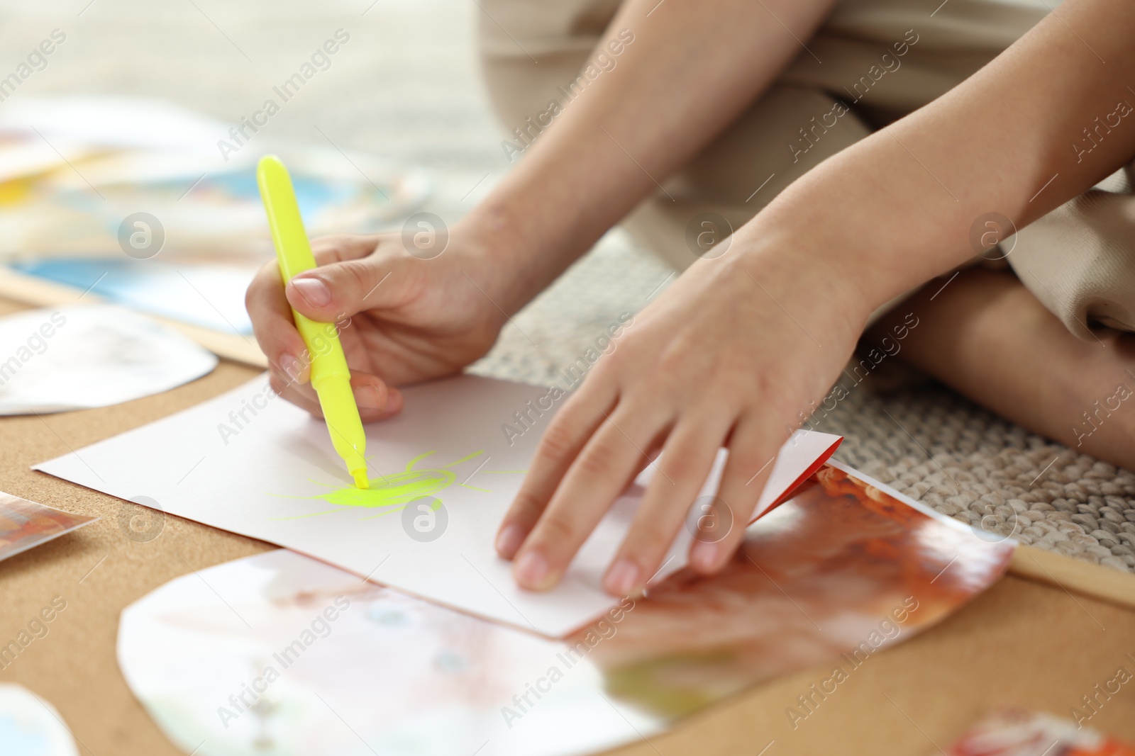 Photo of Creating vision board. Little boy drawing on paper indoors, closeup