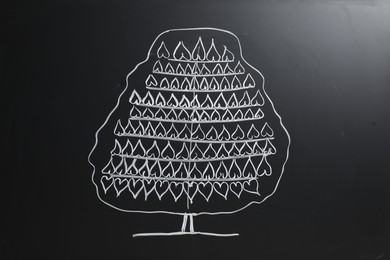 Photo of Beautiful drawing of tree on black chalkboard