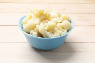 Photo of Tasty cooked cauliflower on white wooden table, closeup