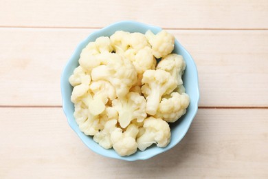 Photo of Tasty cooked cauliflower on white wooden table, top view